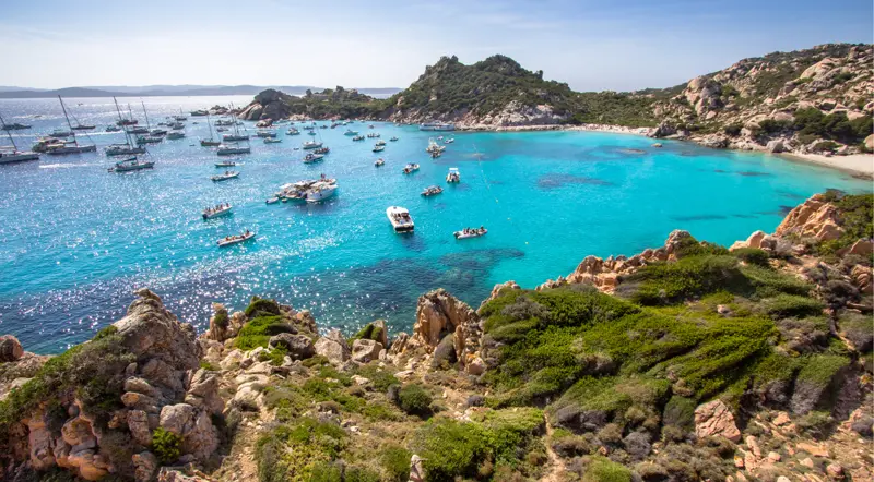 Boats anchored in the shallow natural pools near Budelli, La Maddalena